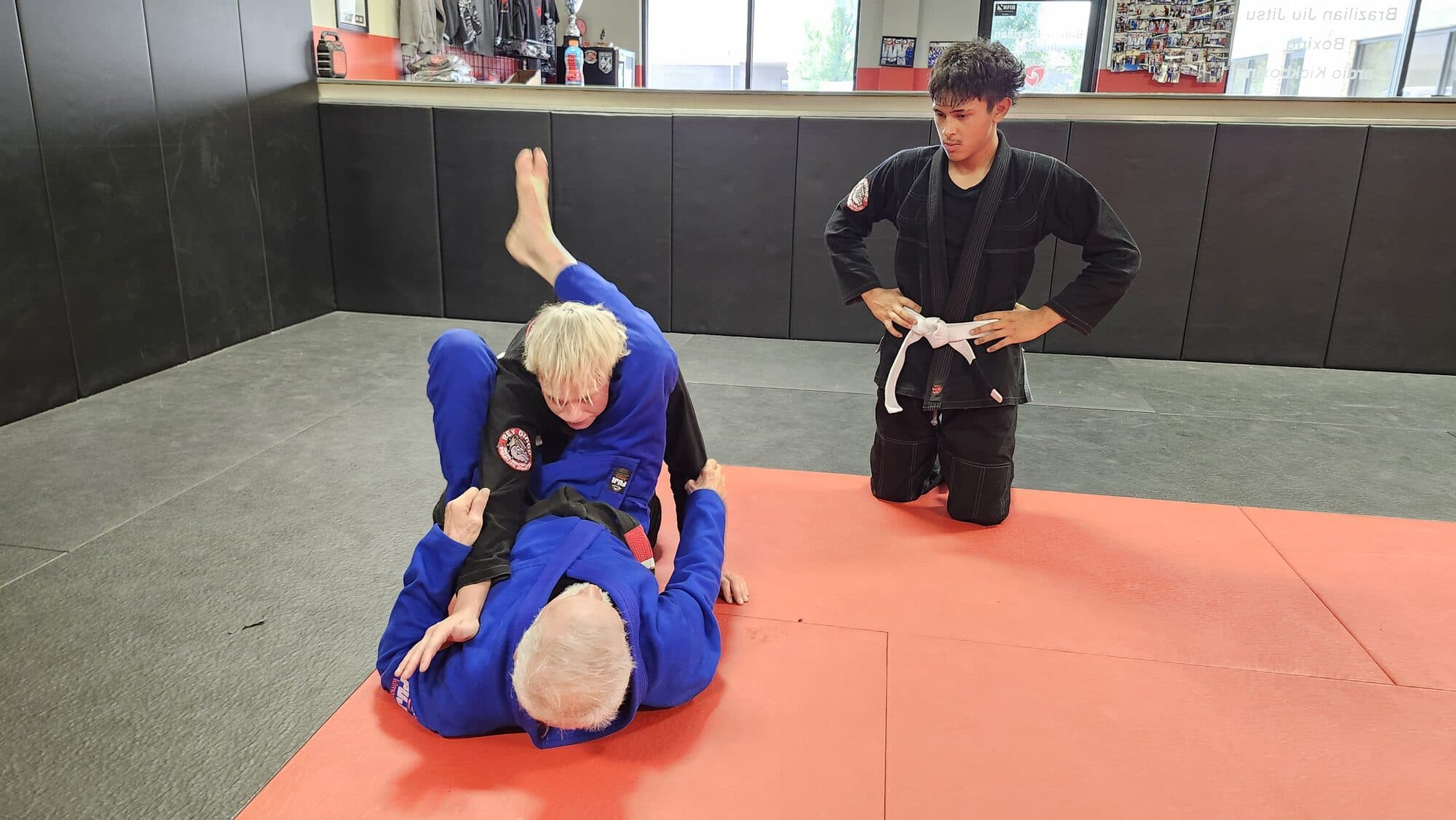 A coach explaining a technique to students during class at Barrick BJJ in Goshen, Indiana