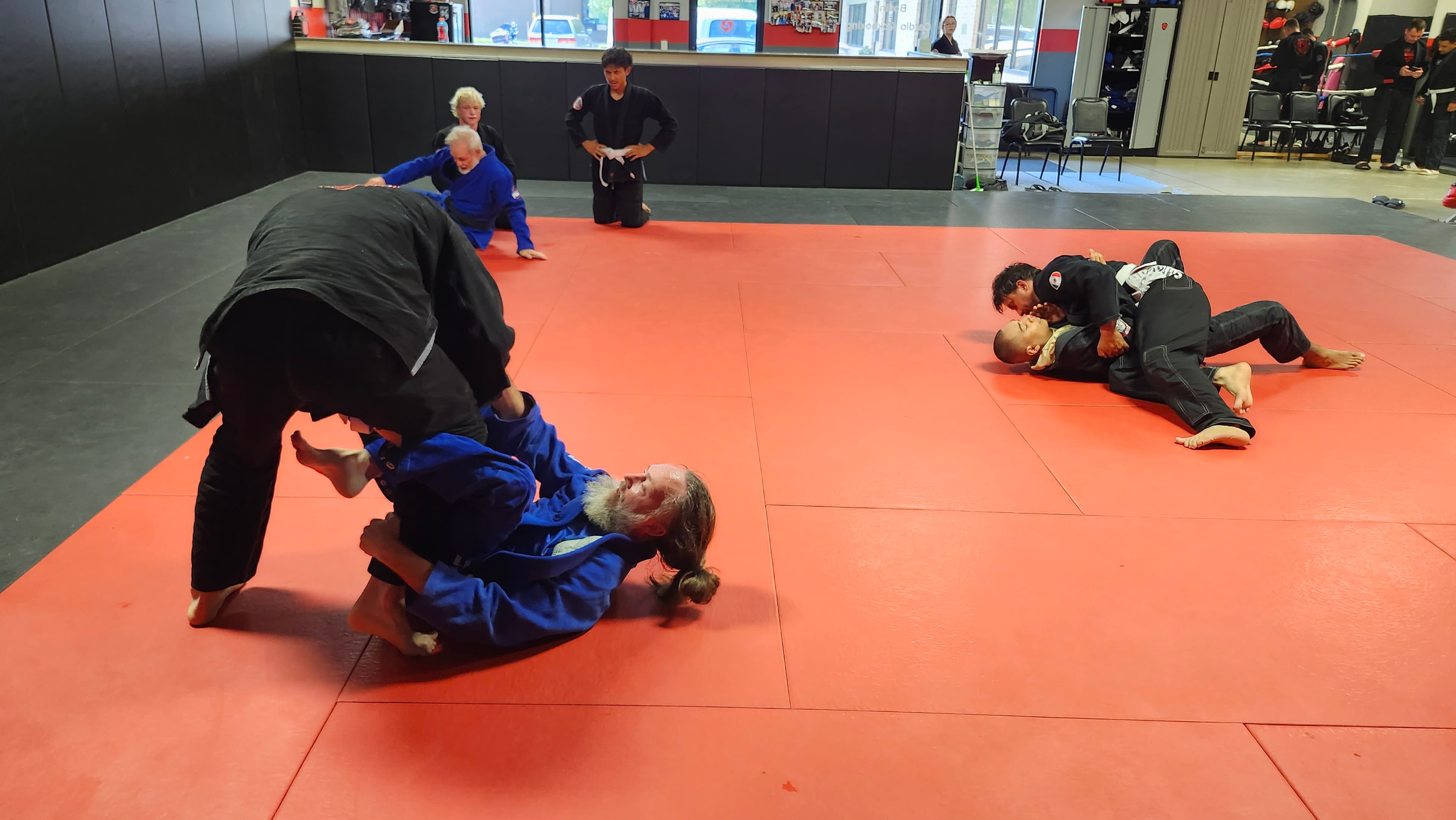 Two Barrick BJJ students drilling a ground technique together