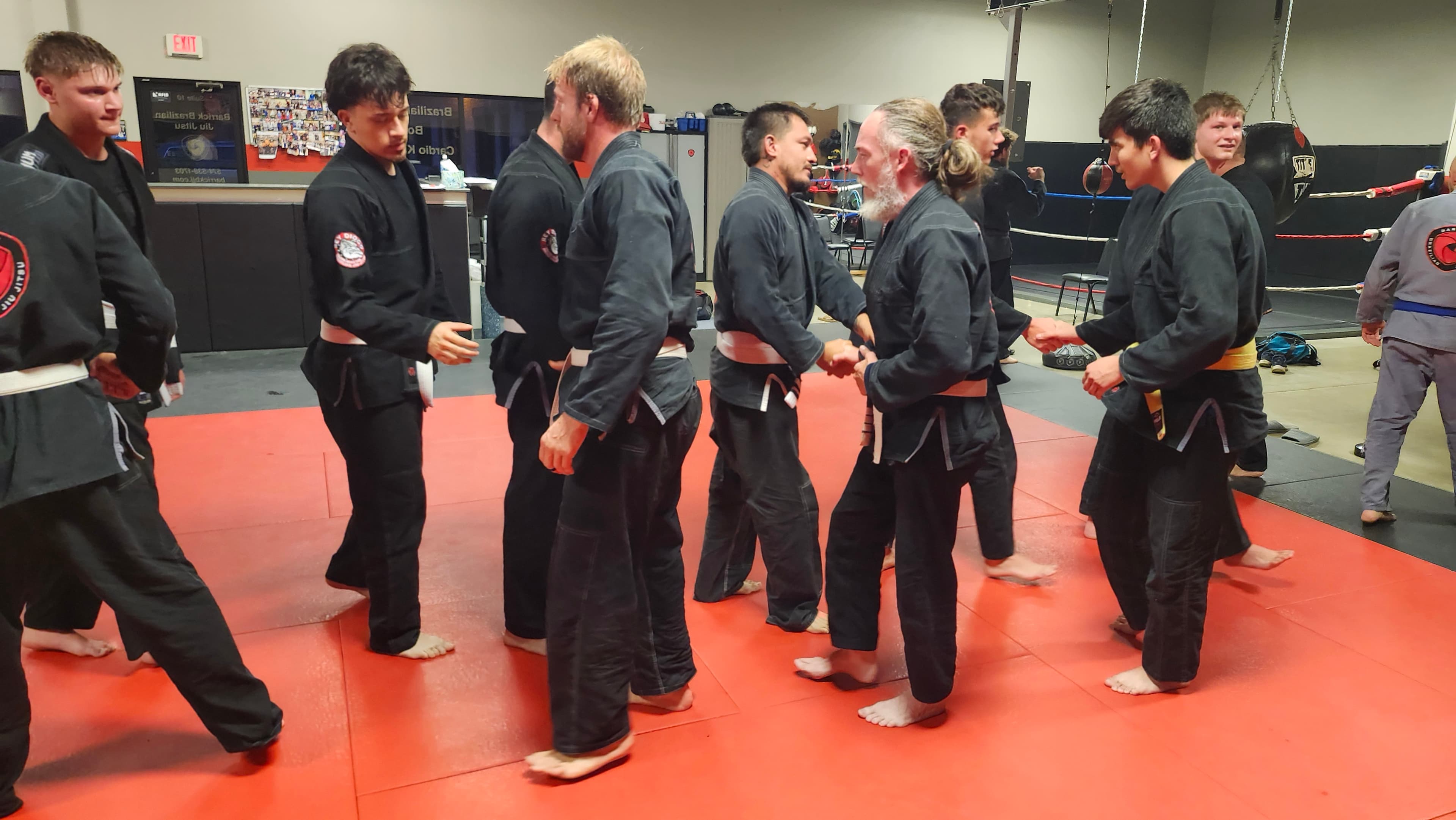Barrick BJJ training partners congratulating one another after class