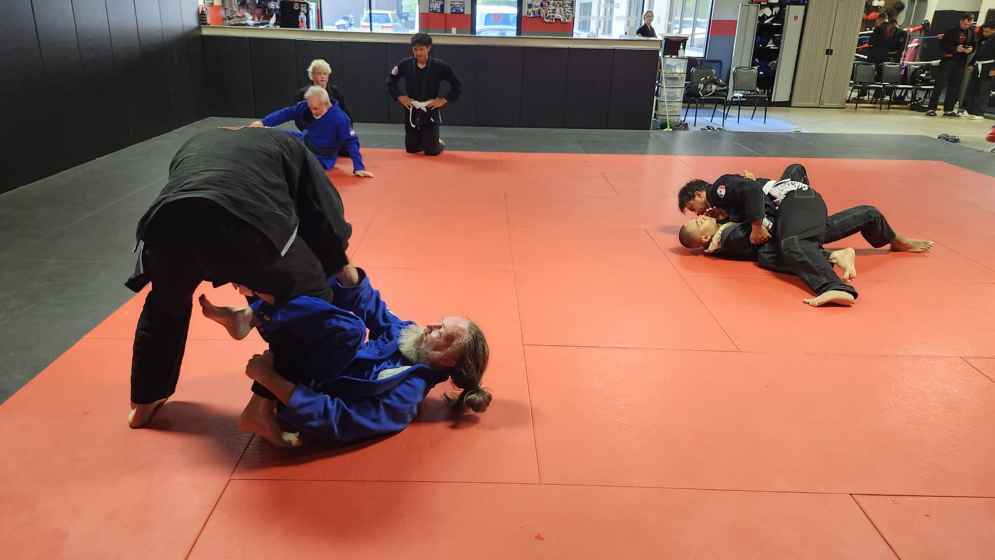 The training floor at Barrick BJJ in Goshen, Indiana, with students working in pairs on the mats