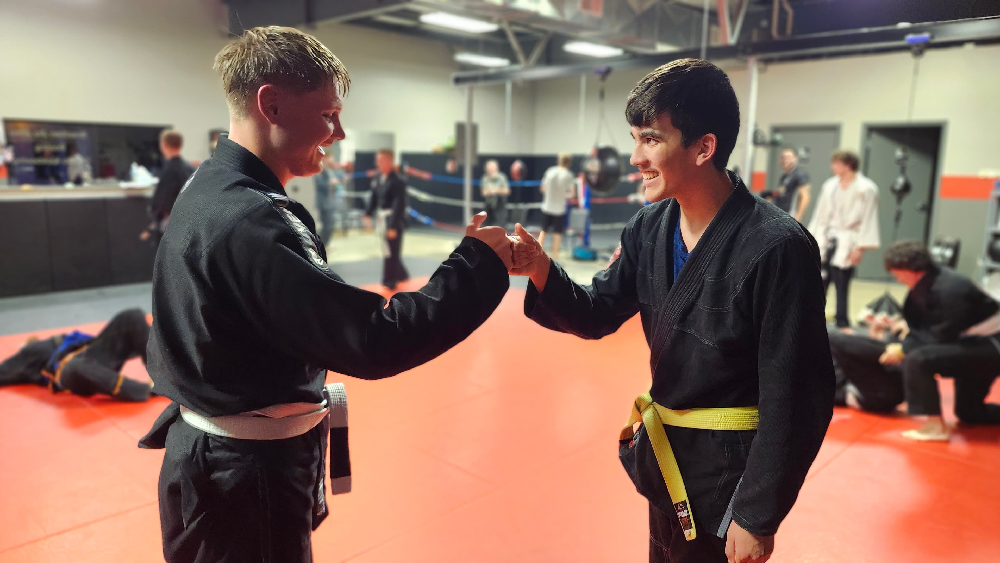 Two teenage Barrick BJJ teammates greeting each other during training